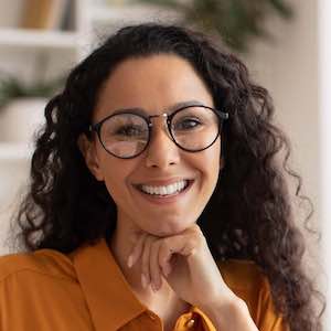 Happy Brunette Business Lady Using Laptop Posing Sitting In Office